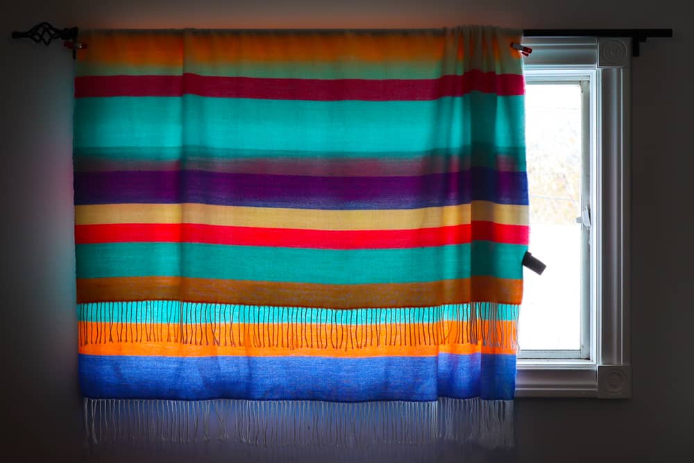 hanging a blanket over a window to block heat