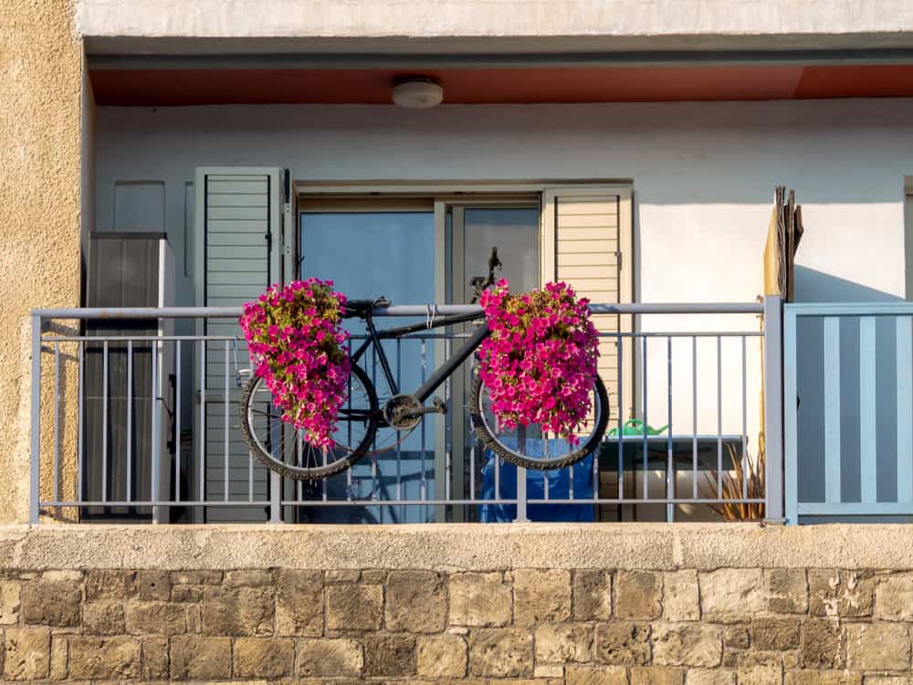 bike stored on a balcony that is fixed to the balcony railing