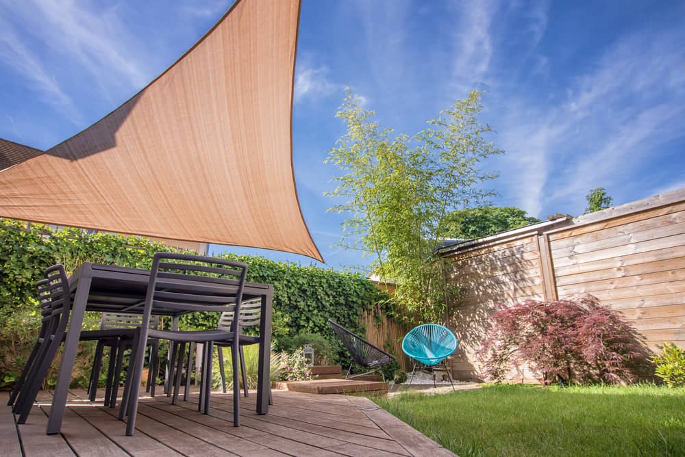 shade sail helping block wind on a patio